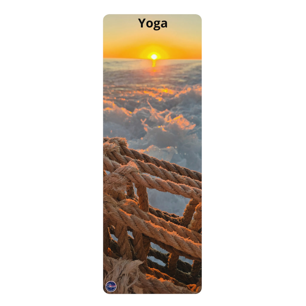 A vertical yoga mat featuring a scenic print of a sunset over waves with a rope railing in the foreground and the word 'Yoga' printed at the top.