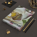 A floral hardcover journal with the word 'Journal' printed on the cover.